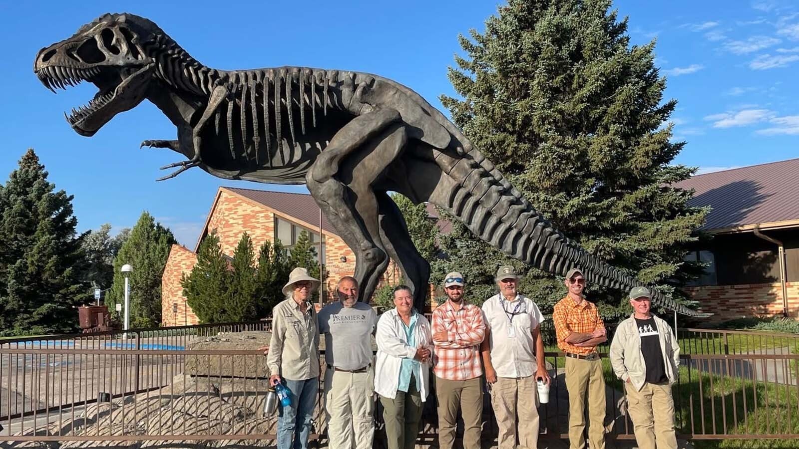 The "jacket recovery crew" — Marianna DePratter, Bryan Aivazian, Melissa Connely, Aidan Murphy, JP Cavigelli, Andrew Rossi, and Dan Kurfis - posing in front of "Essence of Rex," a bronze sculpture by Chris Navarro, at the Tate Geological Museum in Casper.