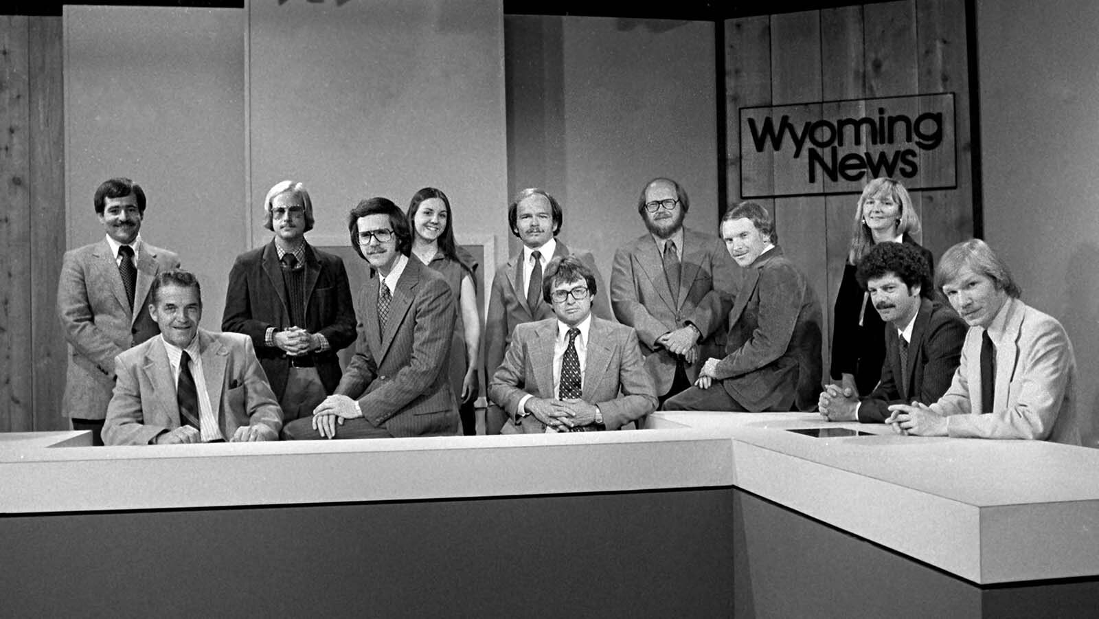 Susan Anderson, far right standing under the "Wyoming News" sign, with the rest of the K2 news crew in the early 1980s. Pete Williams is sitting on the desk.