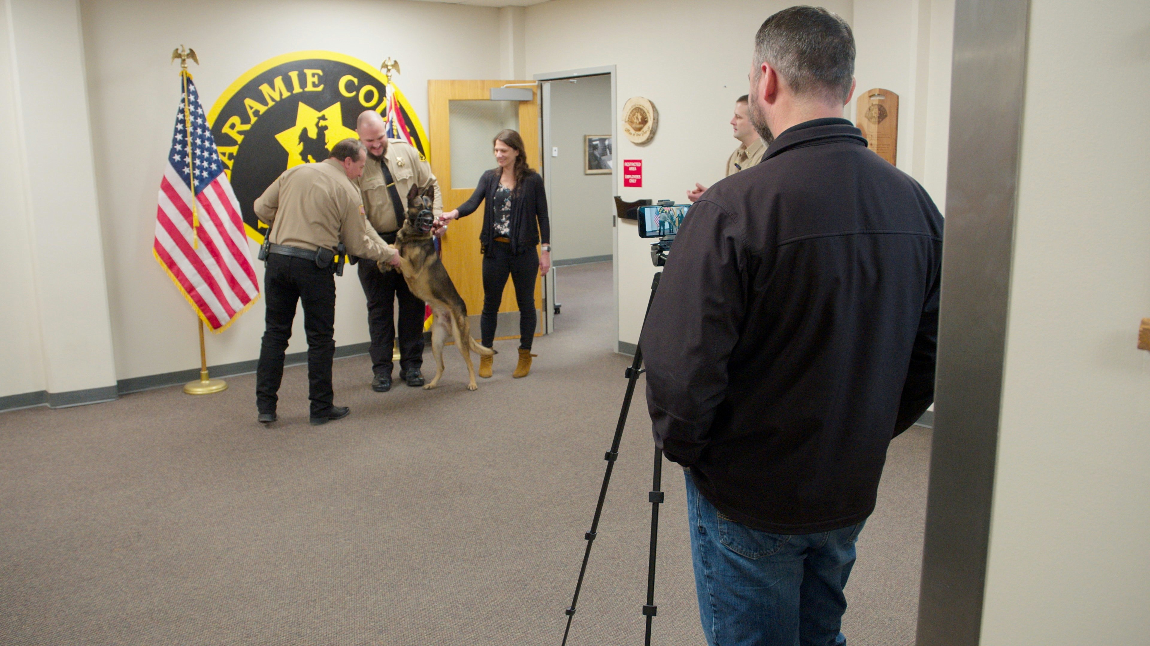 Sheriff Brian Kozak shakes the paw of his department’s newest K-9, Cash. Kozak swore in Cash and his handler on Feb. 5, 2025.