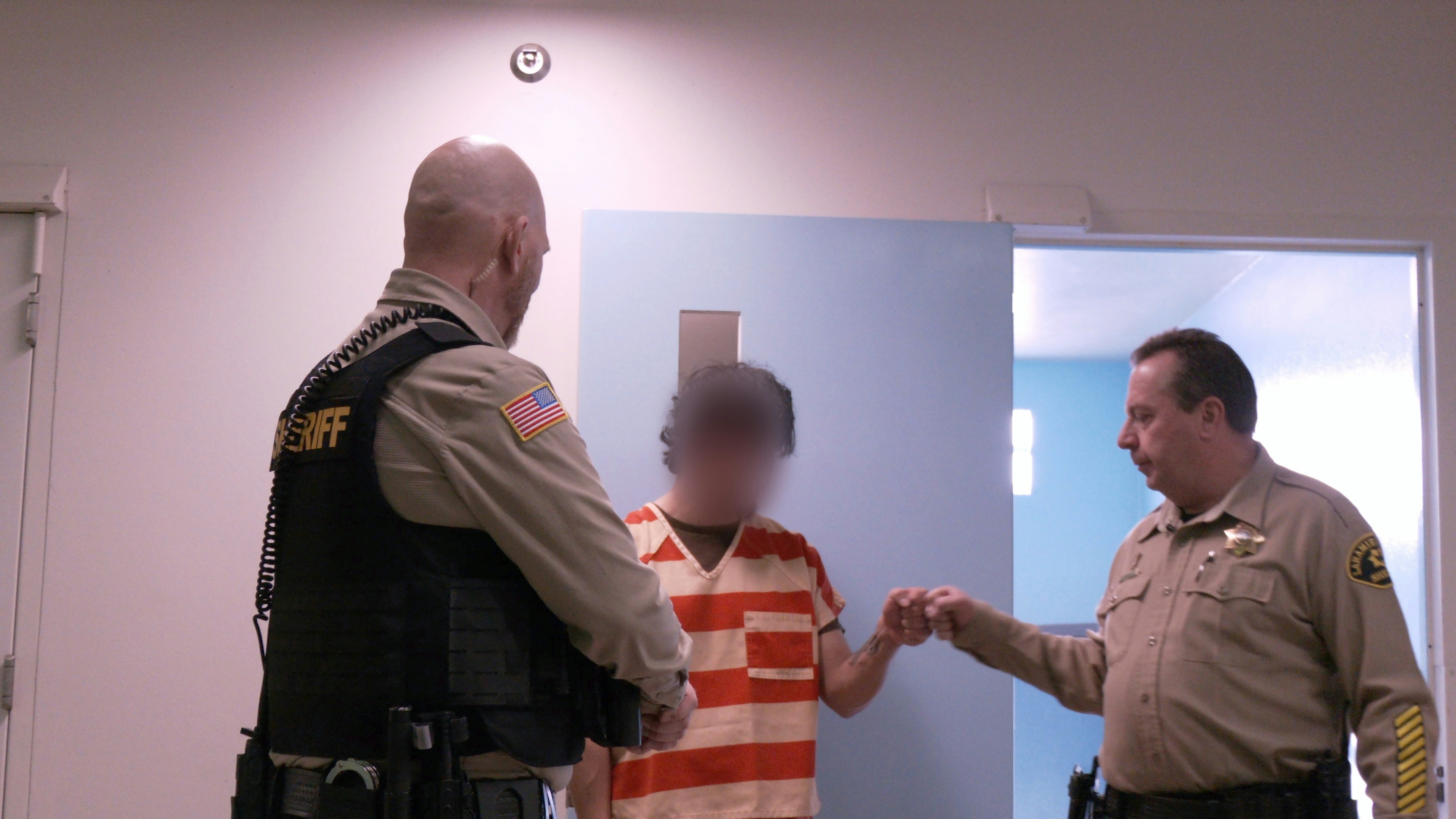 A fist bump is shared between Sheriff Brian Kozak and a Laramie County Jail inmate on Feb. 5, 2025. Kozak said he’s tough on crime and jail rules, but once inmates are in the jail, he thinks it’s his job to give them the best resources so they don’t come back.