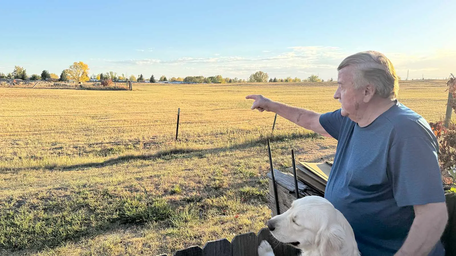 Keith Yosten points to the open land behind his south Cheyenne home where a power transmission line is planned to connect to a Colorado wind farm project. He said he's lived there for 42 years and now fears the impacts the transmission line will have on the area.