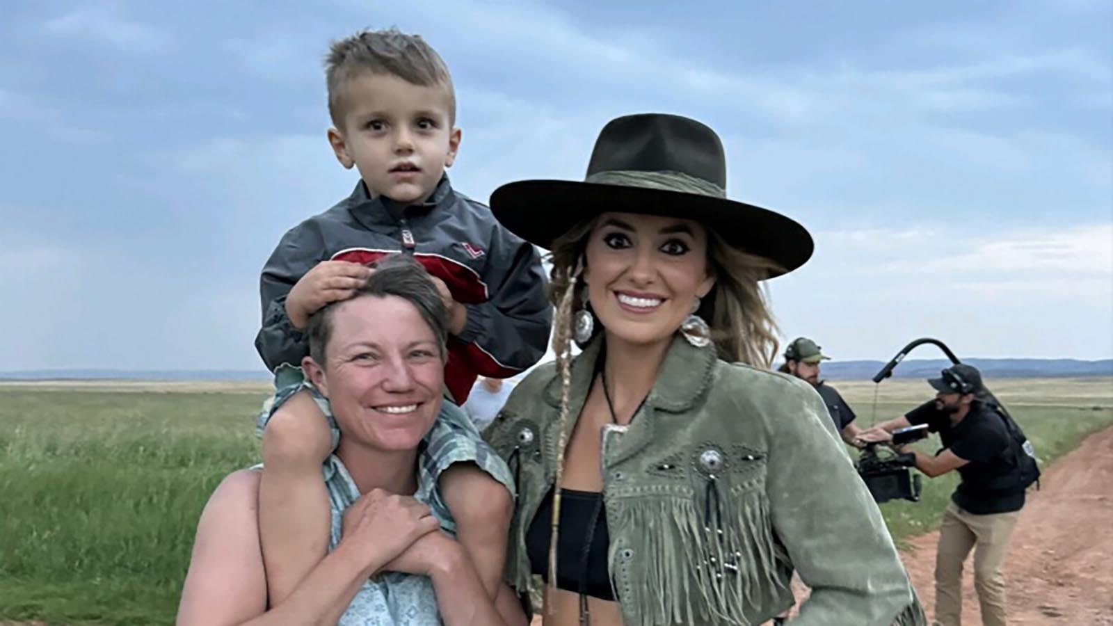 Albany County rancher Kelly McGuire and her son, William, pose with country music superstar Lainey Wilson. Wilson shot scenes for her “Whirlwind” music video at the Oxford ranch south of Laramie.