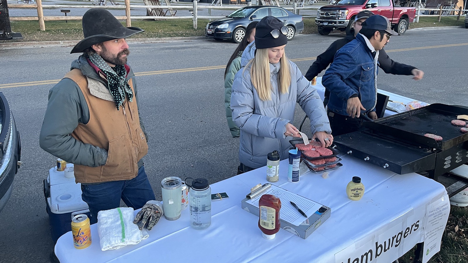 Jake Hutton, left, runs JH Outfitting out of Kelly in the Grand Teton National Park. His horses graze on the parcel in question. He and his crew brought a couple of equine customers and grilled up free hamburgers for attendees Thursday night.