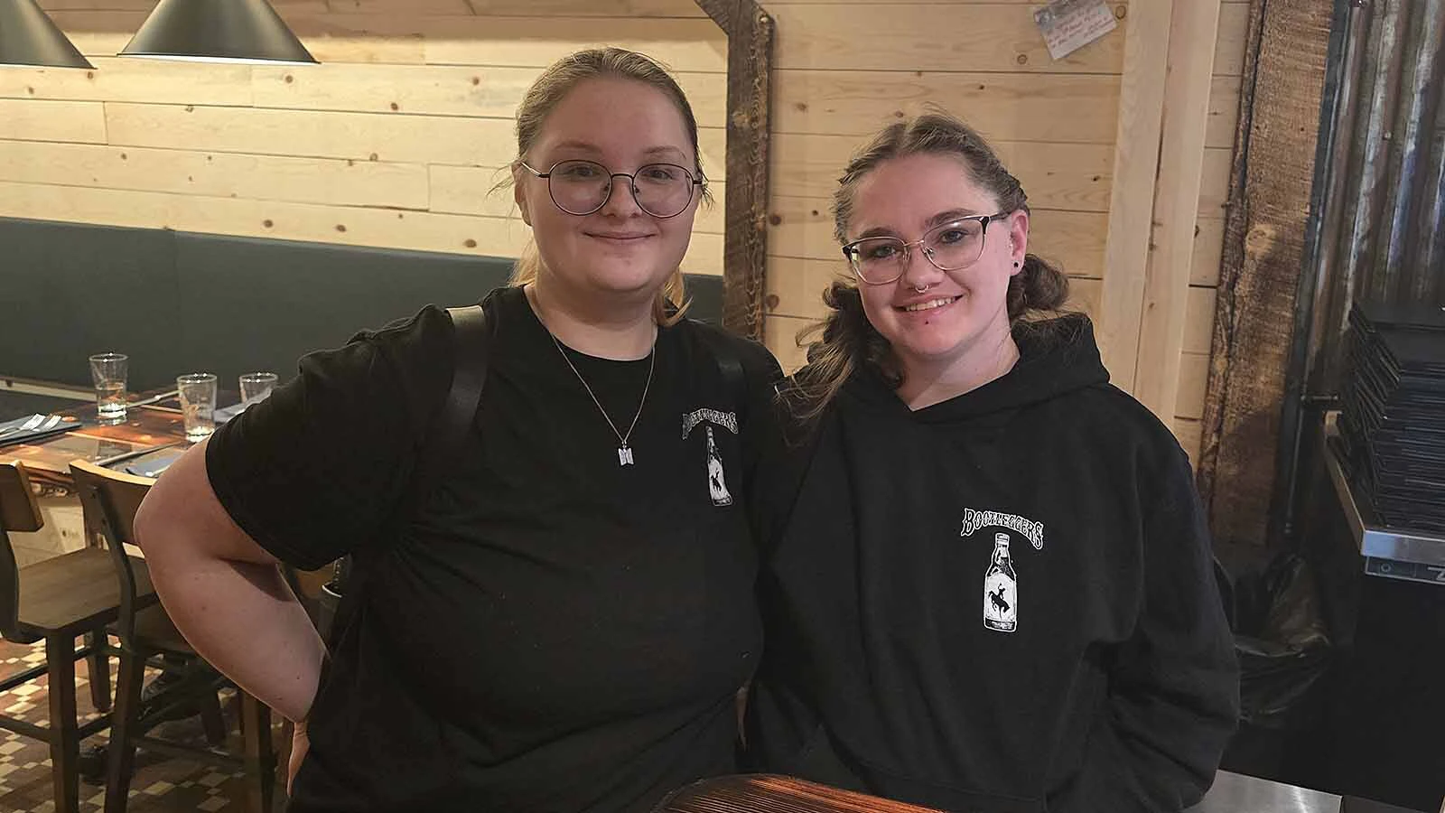 McKinley Chytka and Dakota Gordon pose for a photo after one of their shifts at Bootleggers. They are already seeing rent spikes, they told Cowboy State Daily, and they're worried Kemmerer isn't building new houses fast enough.
