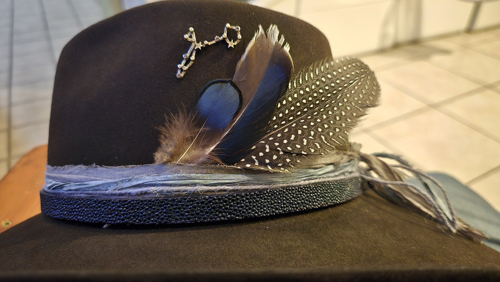 A few feathers — they're free — and a pisces hat pin, which was not free, make the hat unique and personal.