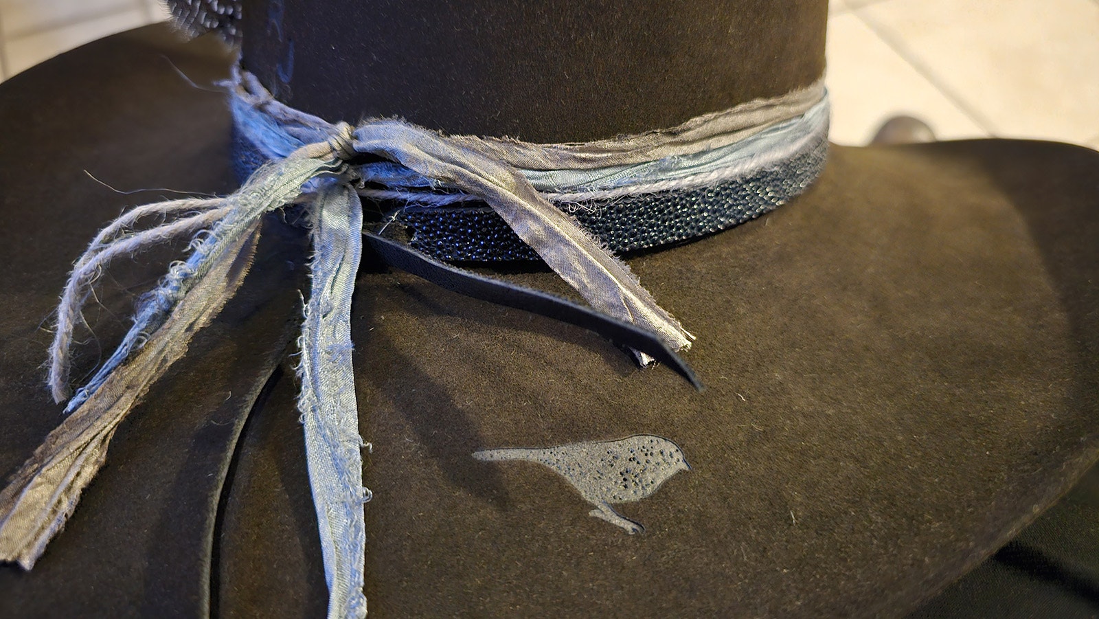 Aquamarine silks for the pisces birthstone, and a little bird logo and initials finish out the hat.