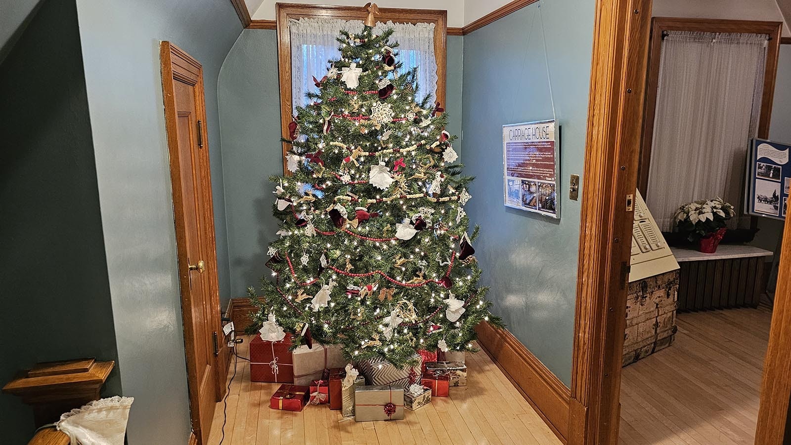 Another beautiful Christmas tree adorns the end of this hall way at the Kendrick Mansion in Sheridan.