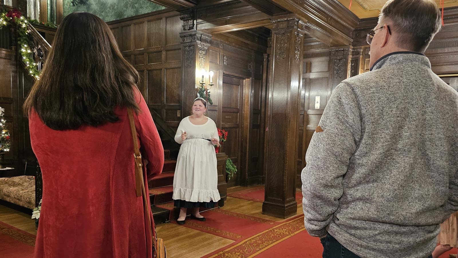 Lucinda Sallers, played by Aubree Helton, talks to newly arrived guests in the foyer of the Kendrick Mansion in Sheridan.