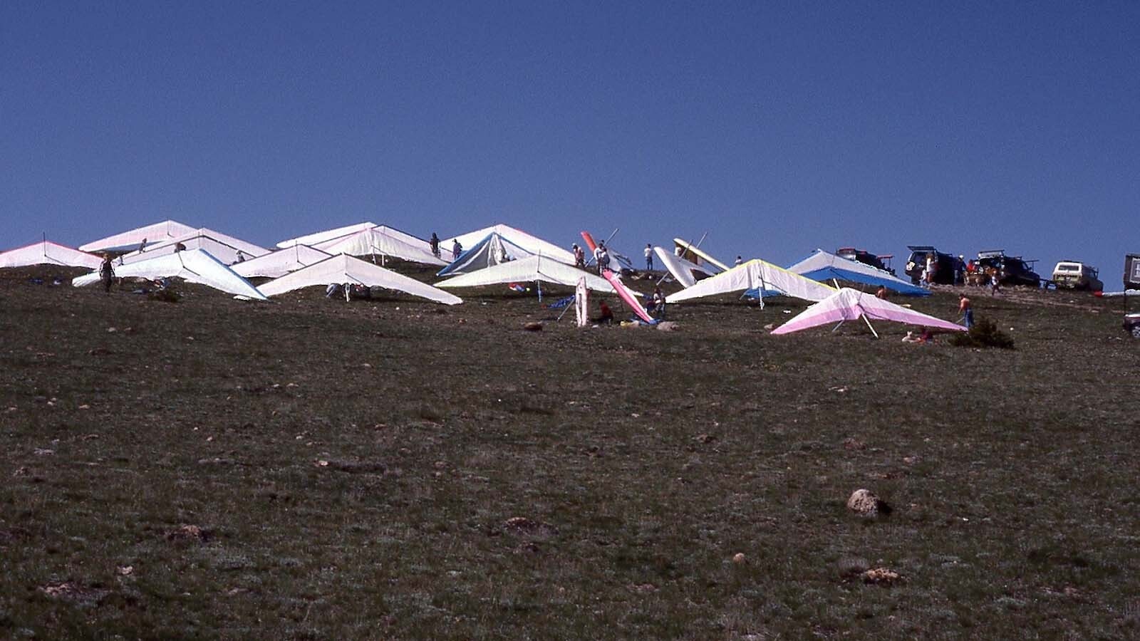 Hang gliders are assembled for a competition and day of soaring.