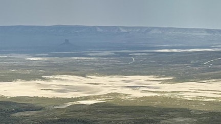 The vast Killpecker Sand Dunes are visible from the top of Steamboat Mountain. Boars Tusk is visible in the distance.