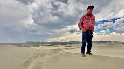 Pat White struggles to find his footing on top of a big dune.