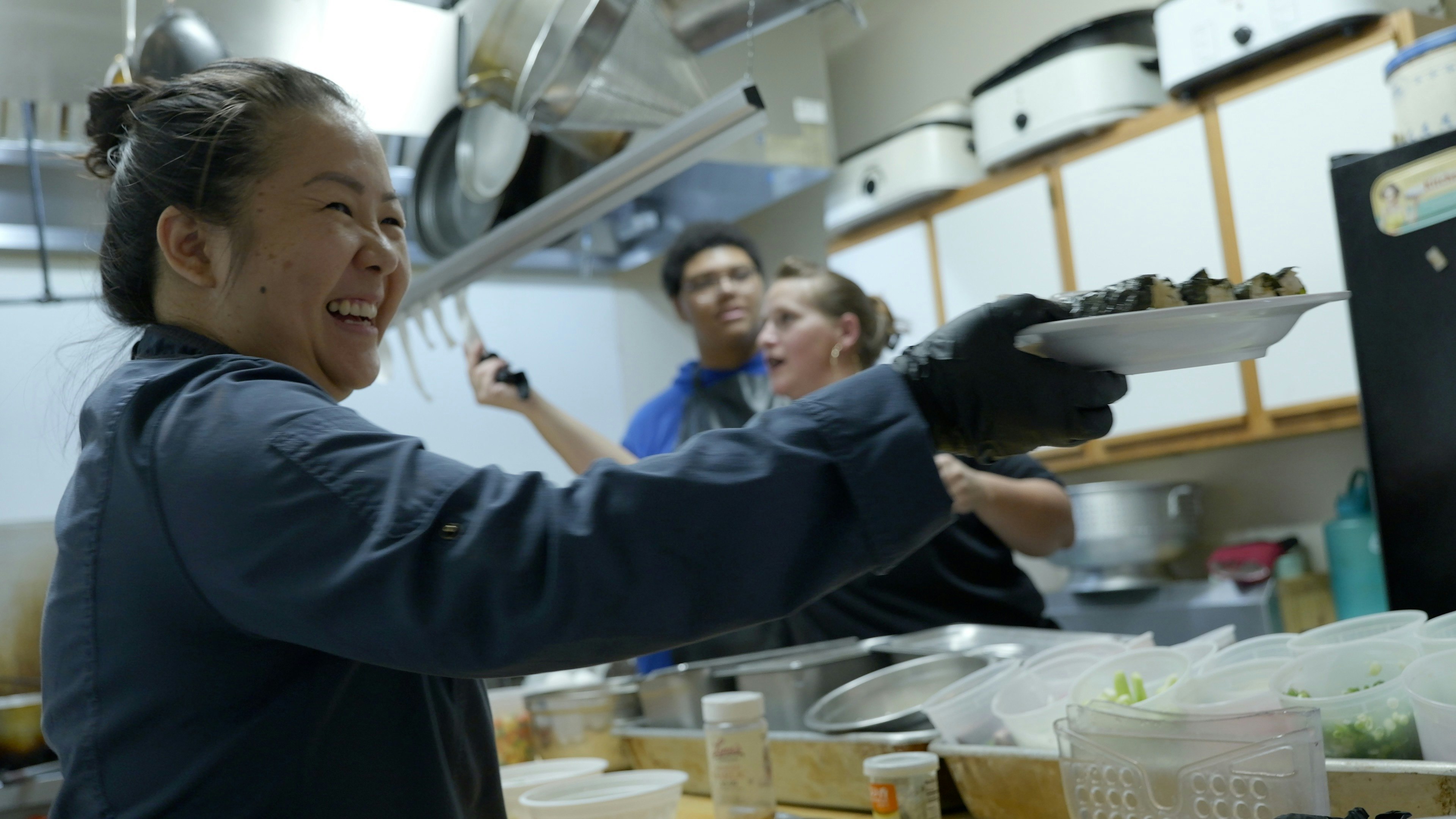 V Cafe Owner KimChi Vu serves up an order on June 21, 2025.