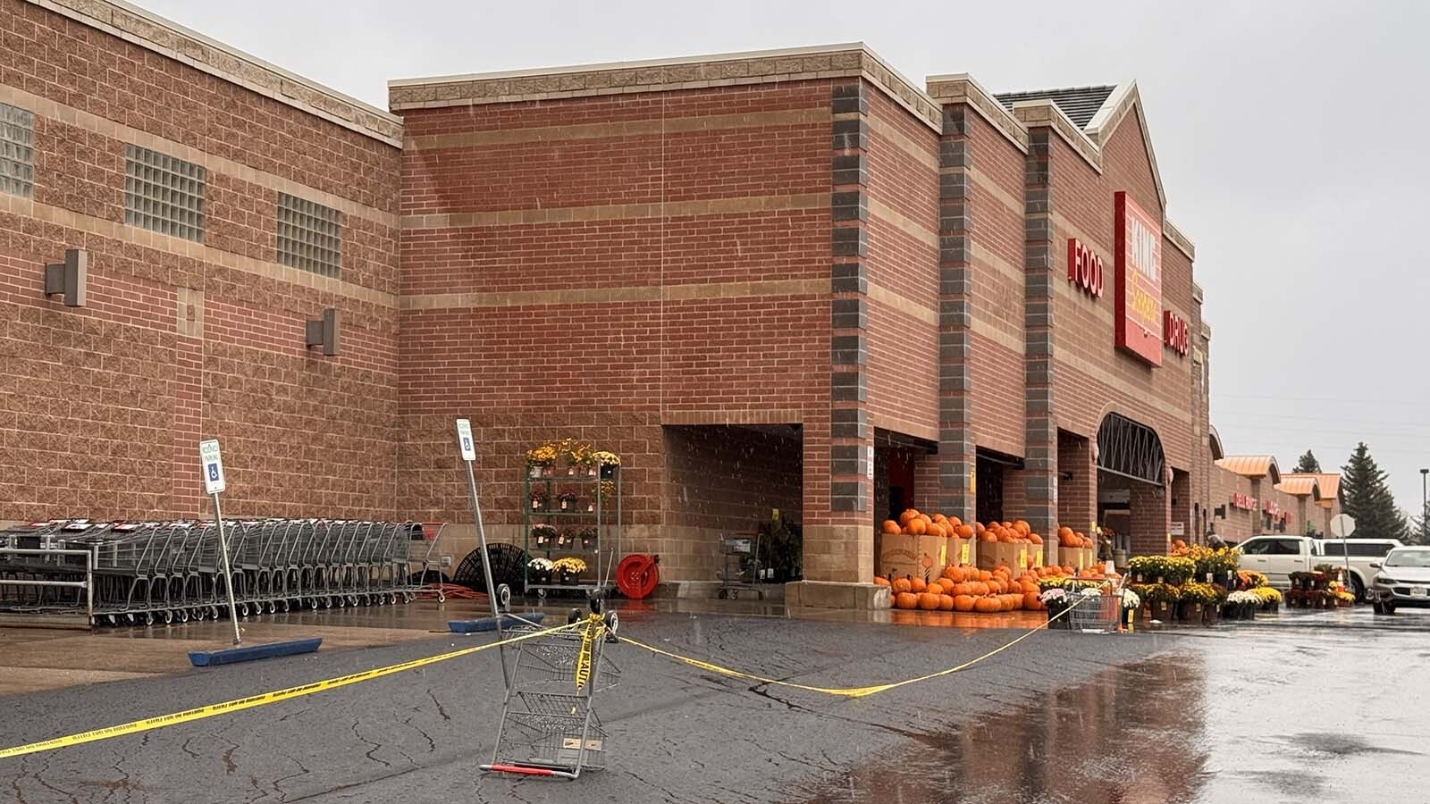 Yellow caution tape blocks off a bank of parking spaces on the west side of the Cheyenne King Soopers store.