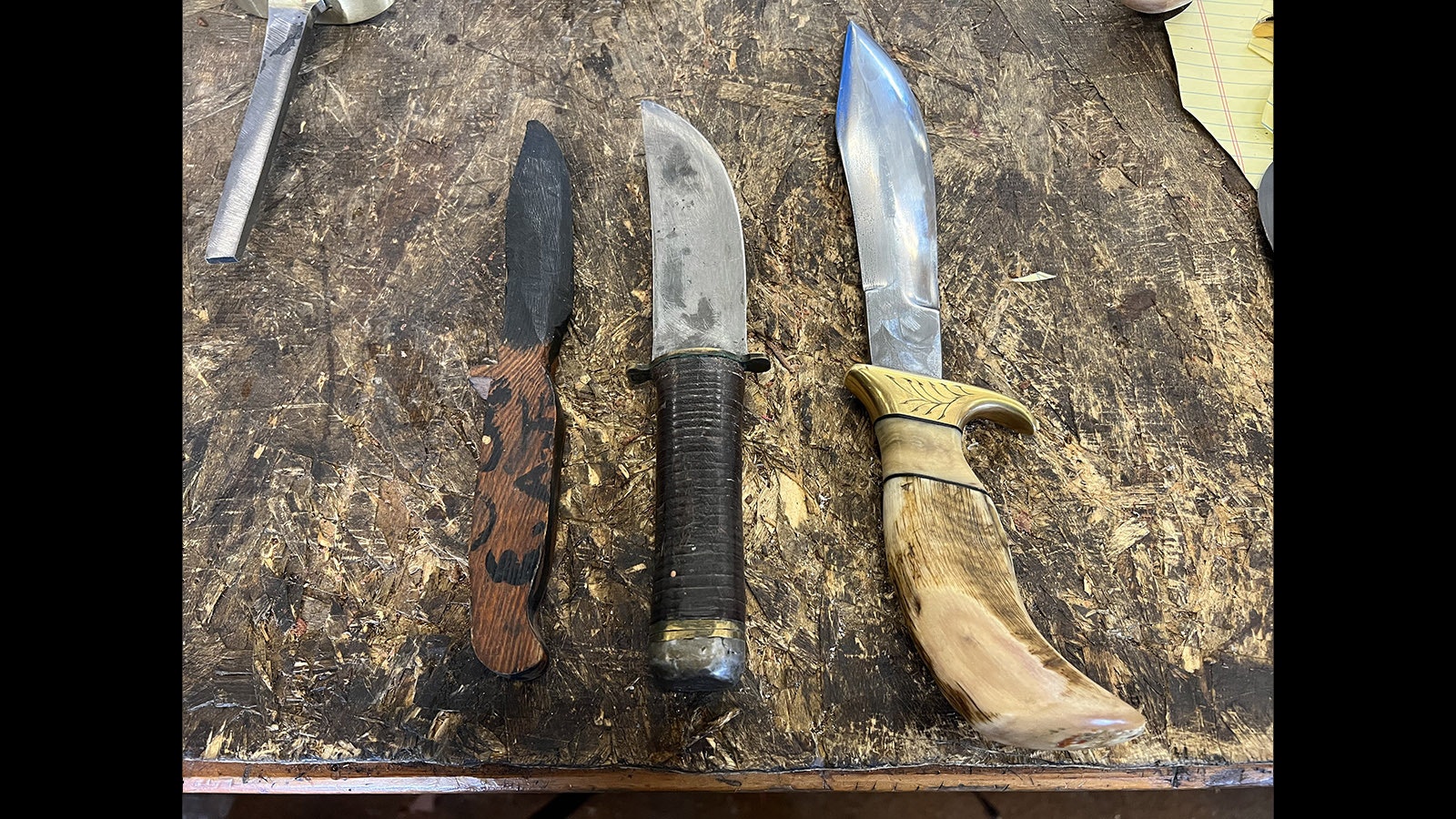The wooden knife on the left was Ed Fowler’s first creation when he was a young boy. The middle blade represents one of his first works crafted from steel. The knife on the right is representative of his work after decades of experience.