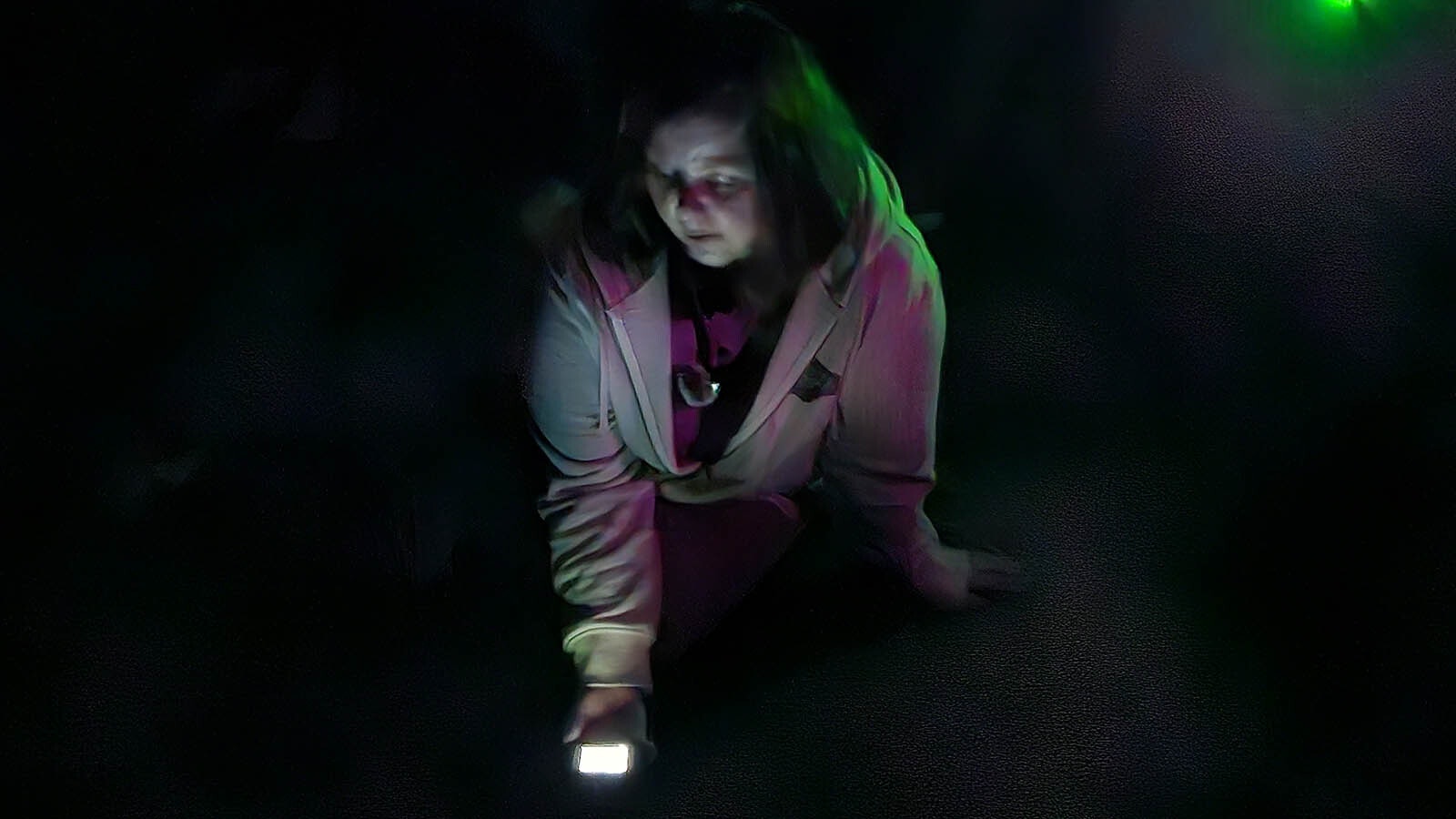 A woman uses an app on her cellphone as an electronic voice protocol device during a paranormal investigation at the Knights of Pythias in Cheyenne.