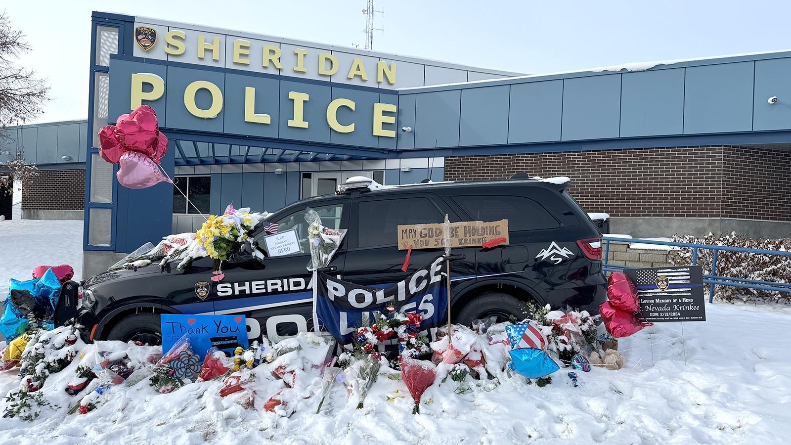 Sgt. Nevada Krinkee's police cruiser is parked in front of the Sheridan Police Department. People have been leaving memorials and messages to the officer who was killed in the line of duty Tuesday.