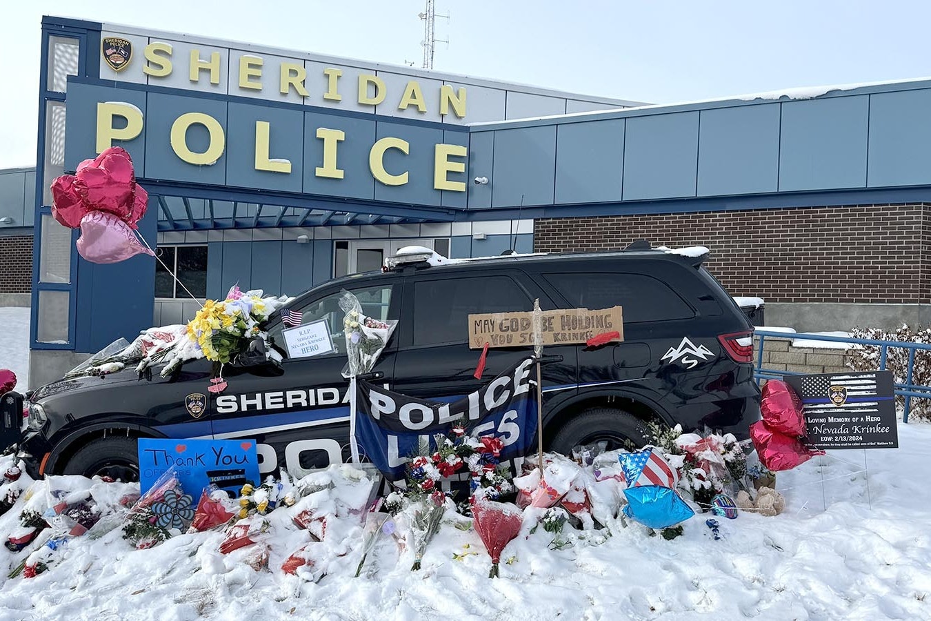 Sgt. Nevada Krinkee's police cruiser is parked in front of the Sheridan Police Department. People have been leaving memorials and messages to the officer who was killed in the line of duty Tuesday.