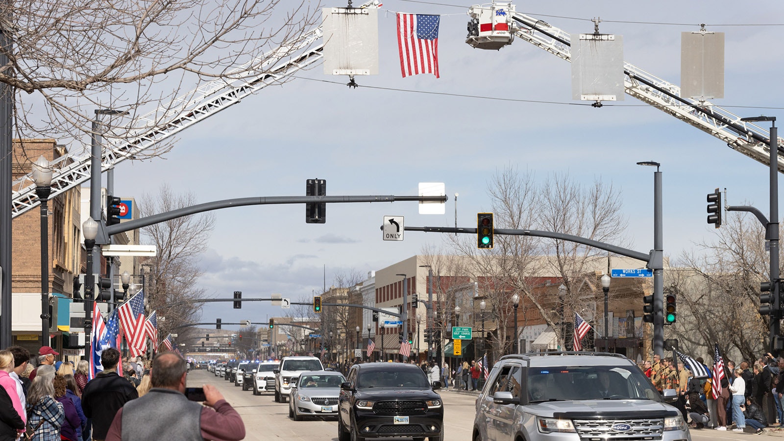 Sheridan residents line the streets downtown Friday to watch a long procession of law enforcement escort the body of Sheridan police Sgt. Nevada Krinkee and his family to a memorial service for the officer, who was killed in the line of duty Feb. 13.