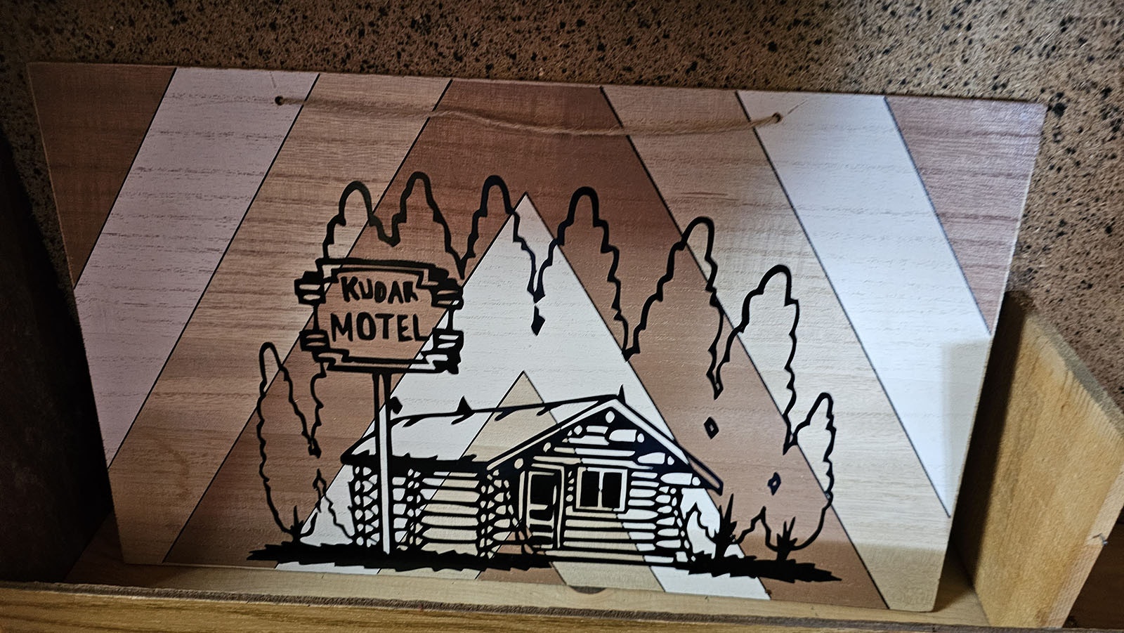 A wood print of the Kudar Motel.