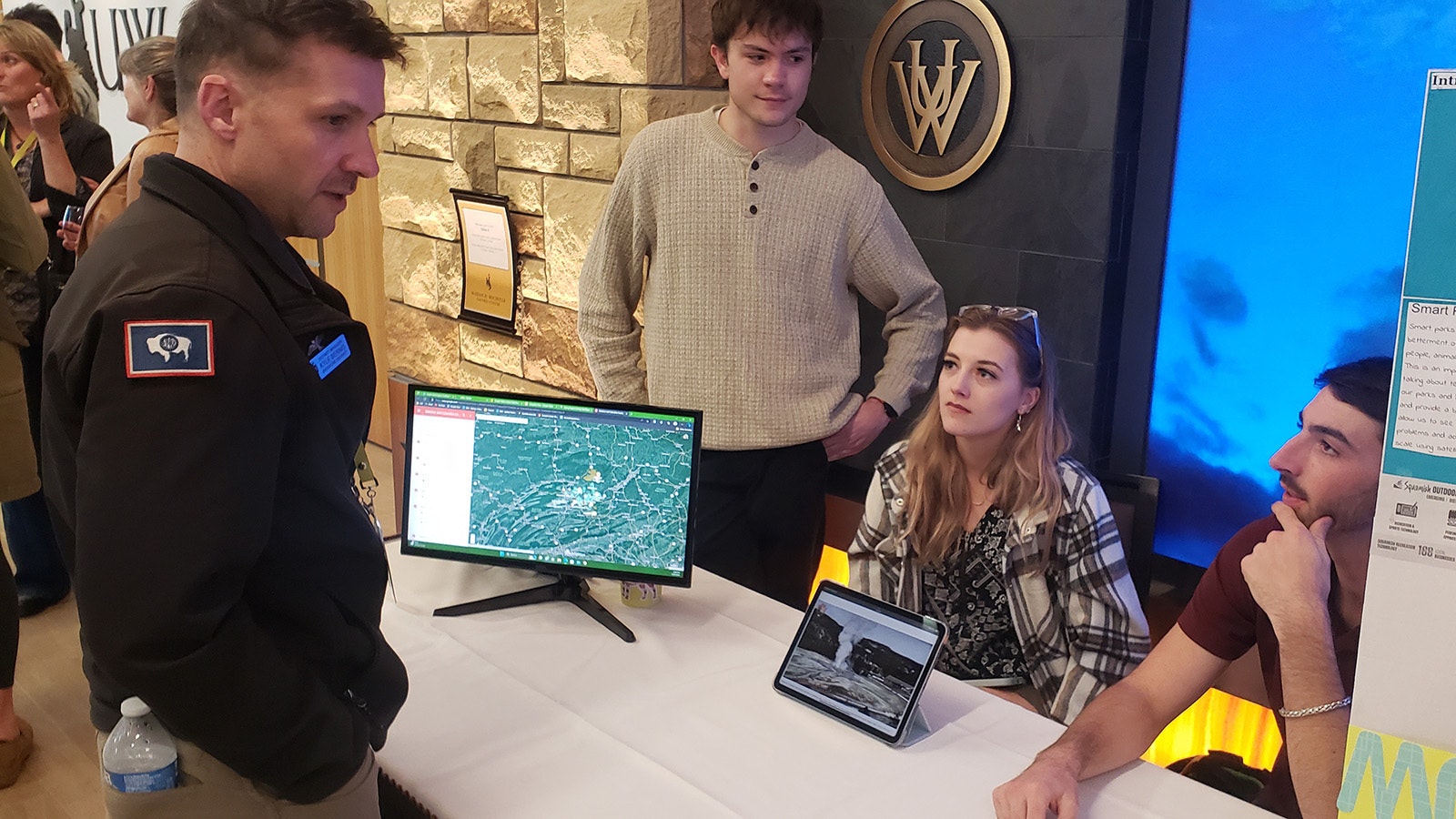 Kyle Bernis, left, talks to Wyoming University students Erik Zafft Sydney Huotari and Colin Loch about Smart Parks during this week's Emerging Issues Forum: Outdoor Recreation: Build It The Way We Want It Conference in Laramie.