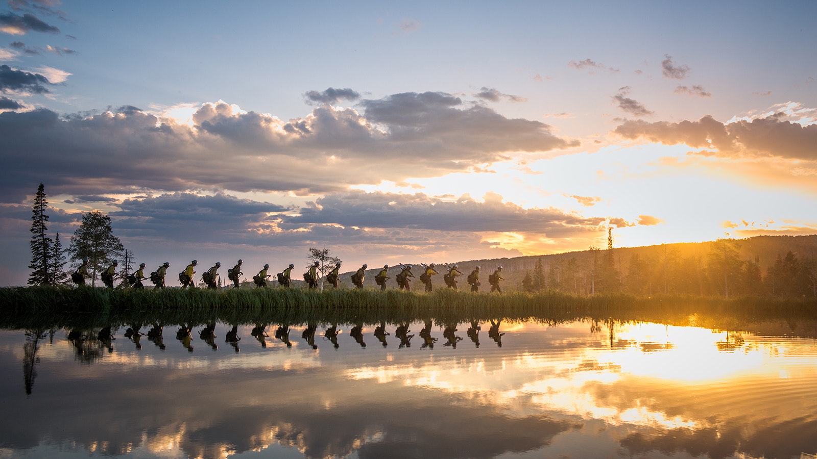 In "Reflections," the crew hikes out for the night during a fire in Colorado. Each member of a hotshot crew carries a pack weighing  an average of 35-55 pounds.