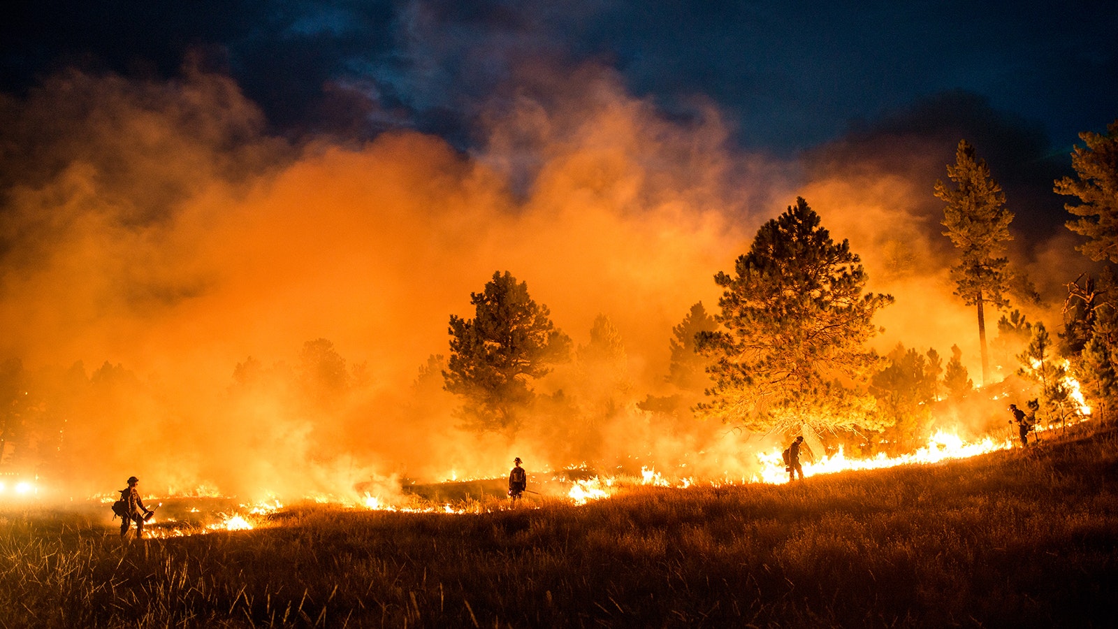 Wyoming Hotshots during a night firing operation. Thick wildfire smoke can significantly reduce visibility by scattering light and create a haze in the atmosphere.