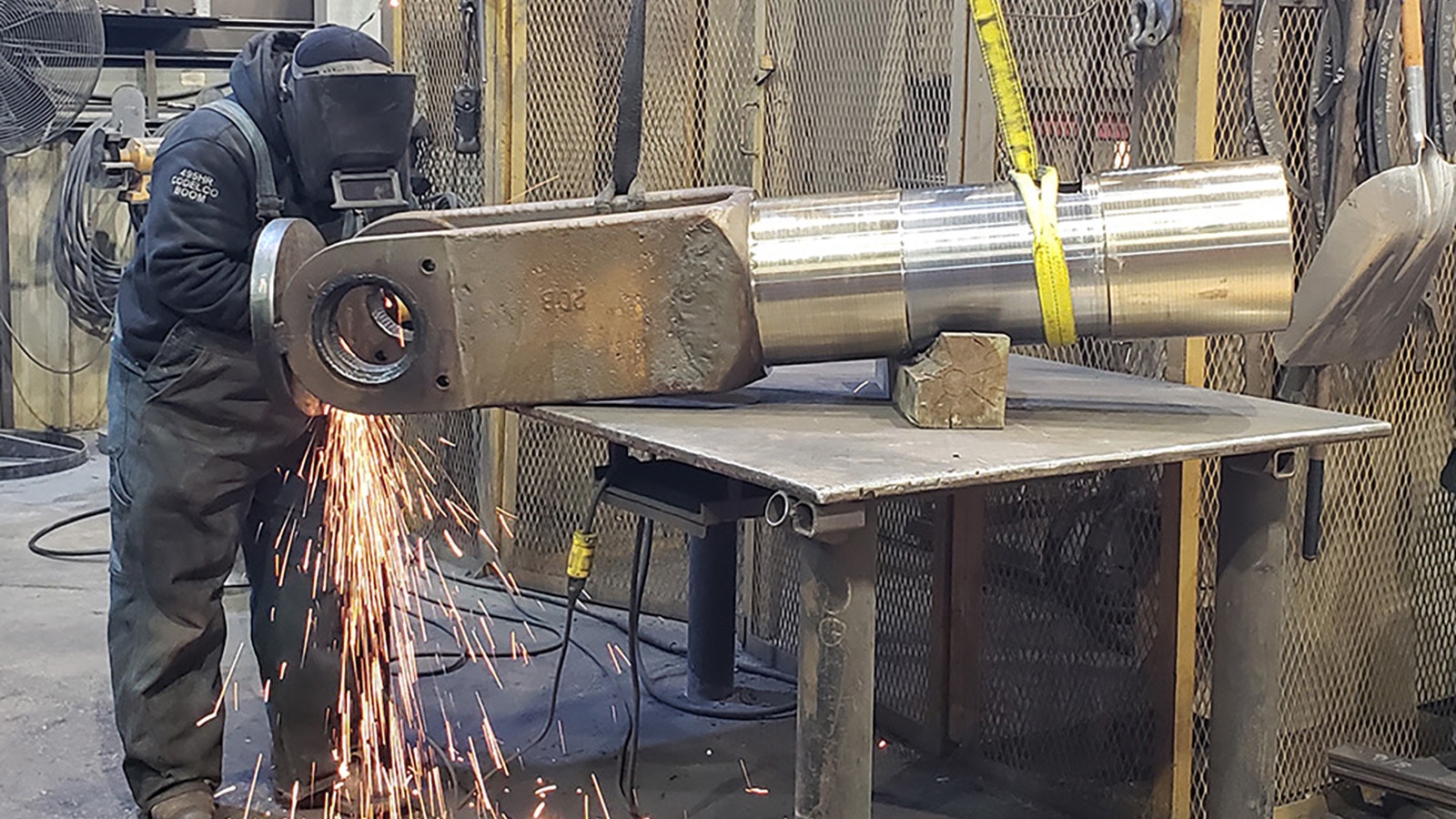 A worker at L&H Industrial in Gillette works on a component for a large piece of machinery.