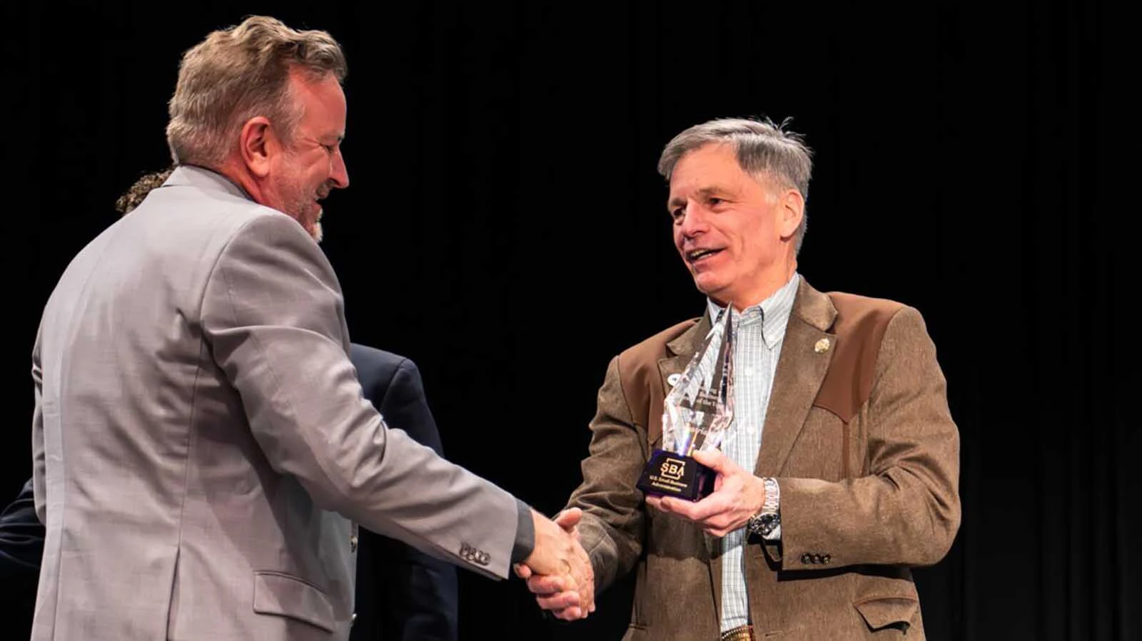 L&H Industrial co-owner Mike Wandler, left, receives the Wyoming 2026 Small Business Person of the Year Award from Gov. Mark Gordon.
