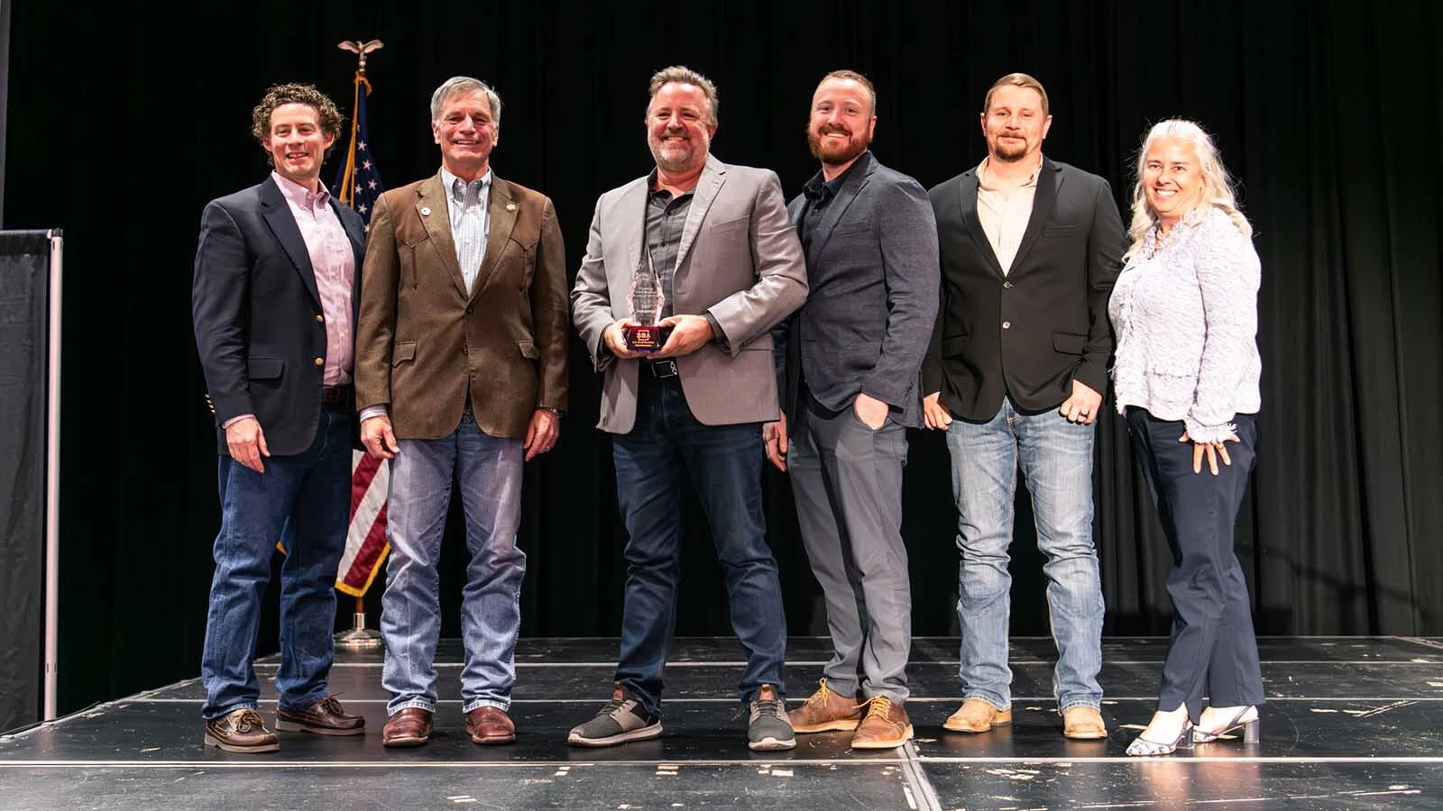 L&H Industrial co-owner Mike Wandler, with Gov. Mark Gordon and other officials after receiving Wyoming's Small Business Person of the Year award.