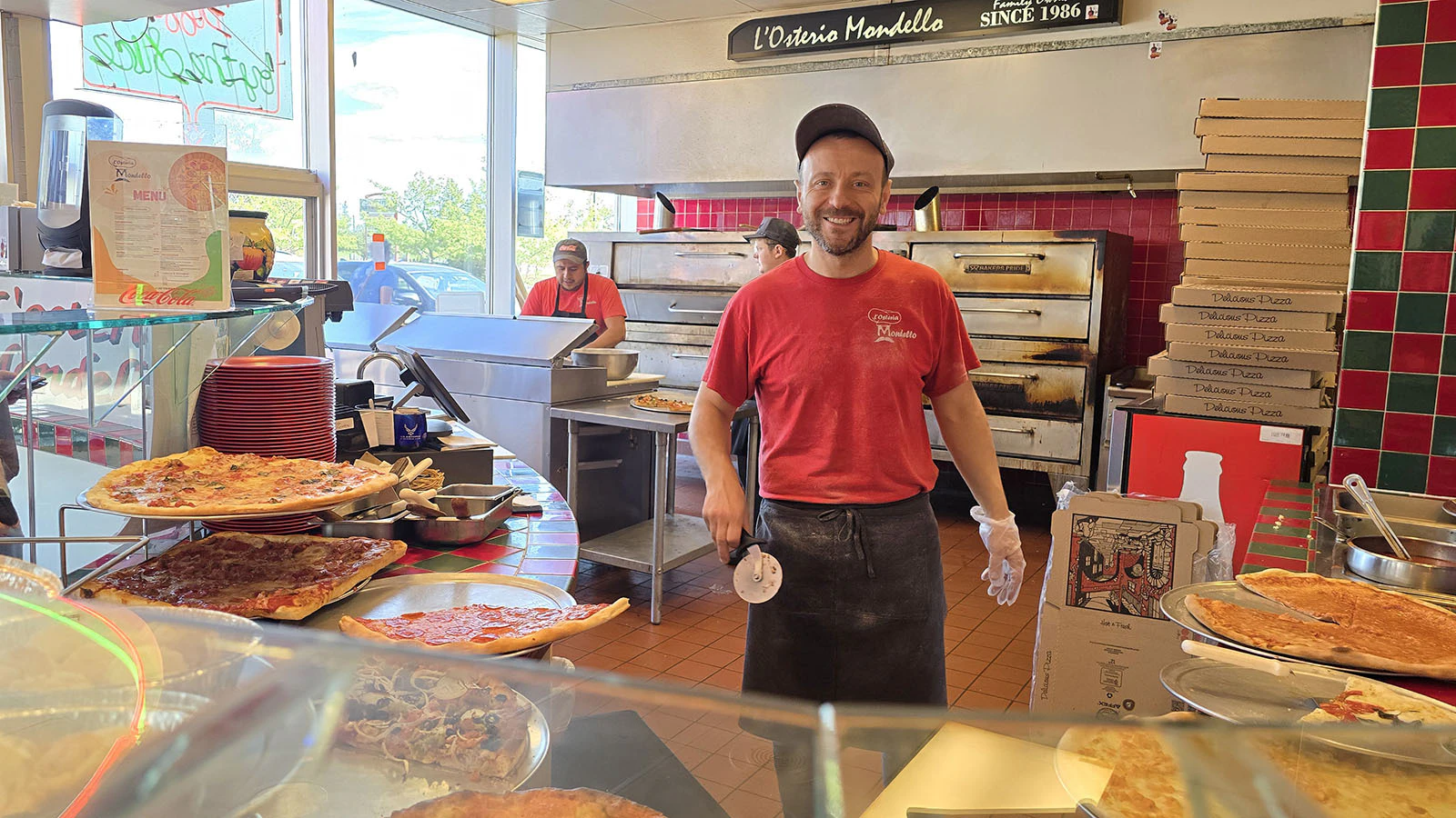 Jasmin “Dave” Agovic usually has a smile when customers walk into L'Osteria Mondello. He views it as setting a good example on the rather large cadre of young workers he has hired.