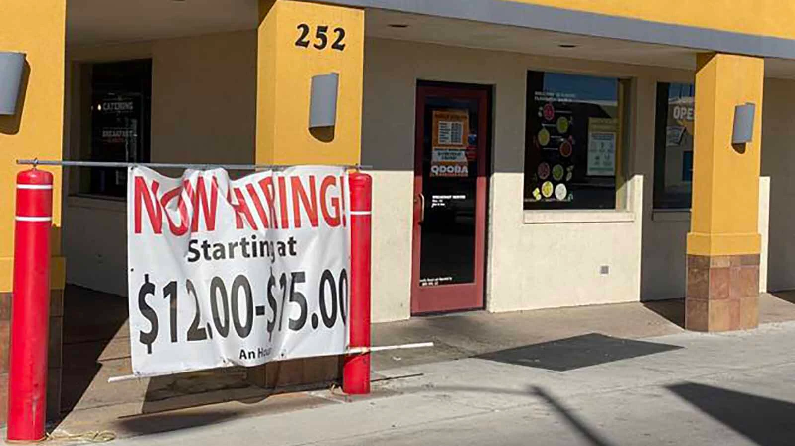 A large sign outside a Laramie restuarant seems desperate to find workers in a file photo.