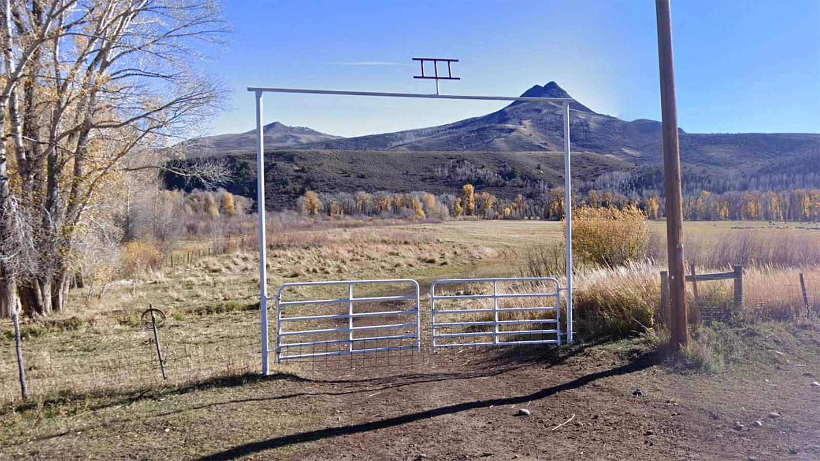 The unassuming gate to the 145-year-old Ladder Ranch in southern Wyoming bears the ladder brand at the top.