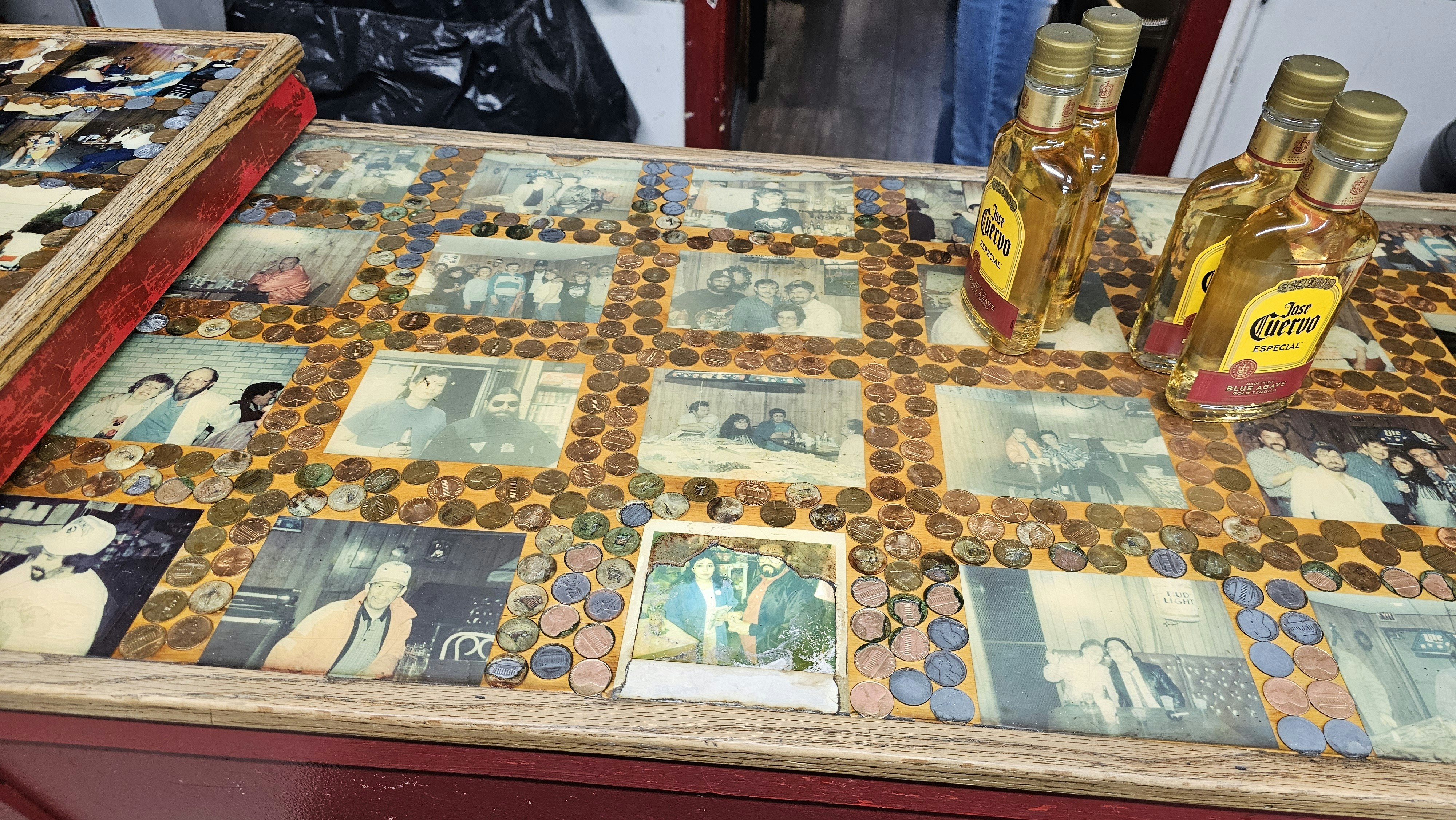 Old photos in one of the penny bar tops in the Lamp Lounge on the south side of Cheyenne.