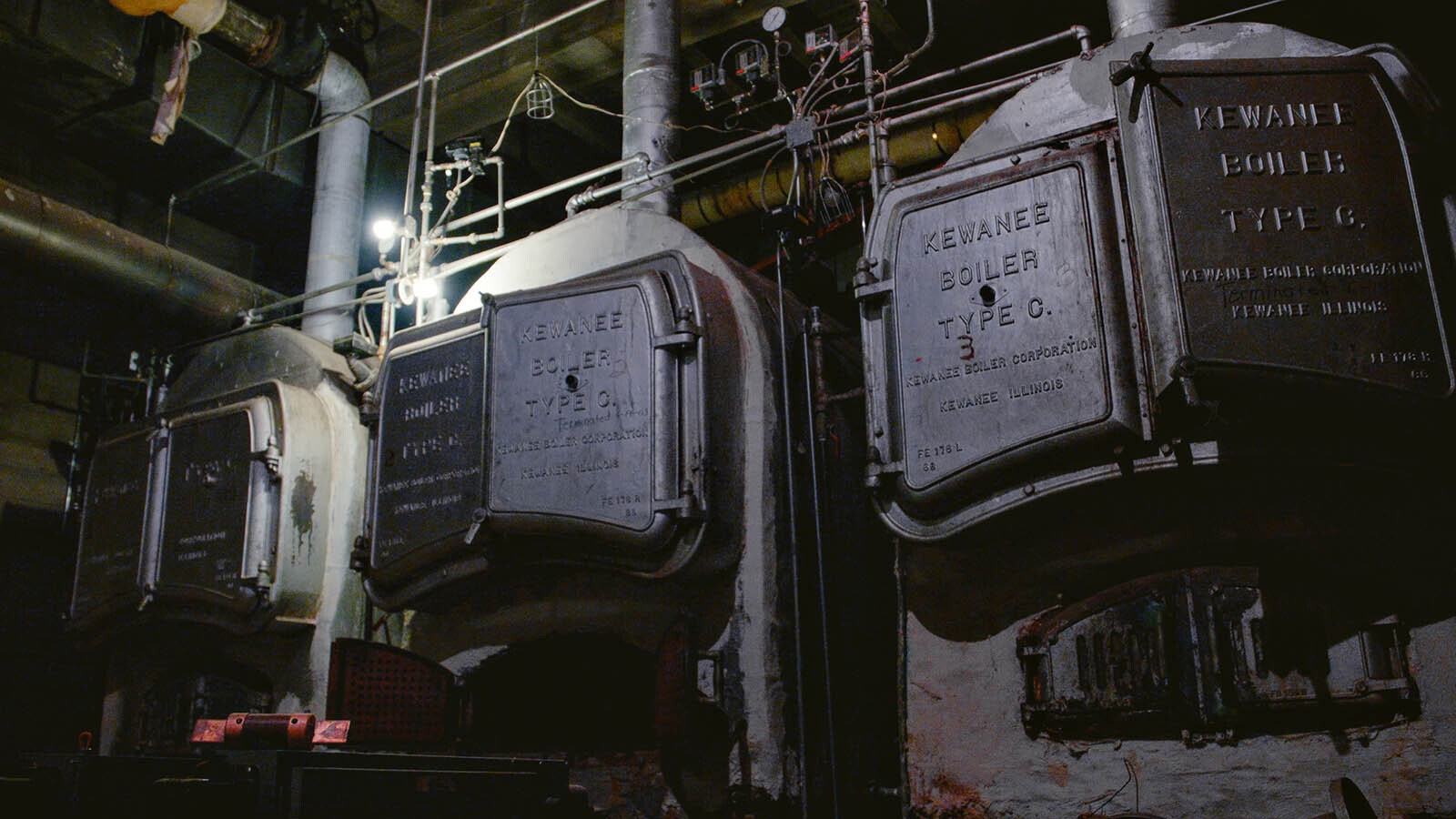 A set of boilers is pictured in the basement of the Laramie Plains Civic Center. The boilers originally used coal and were fueled by coal chutes just across the room.