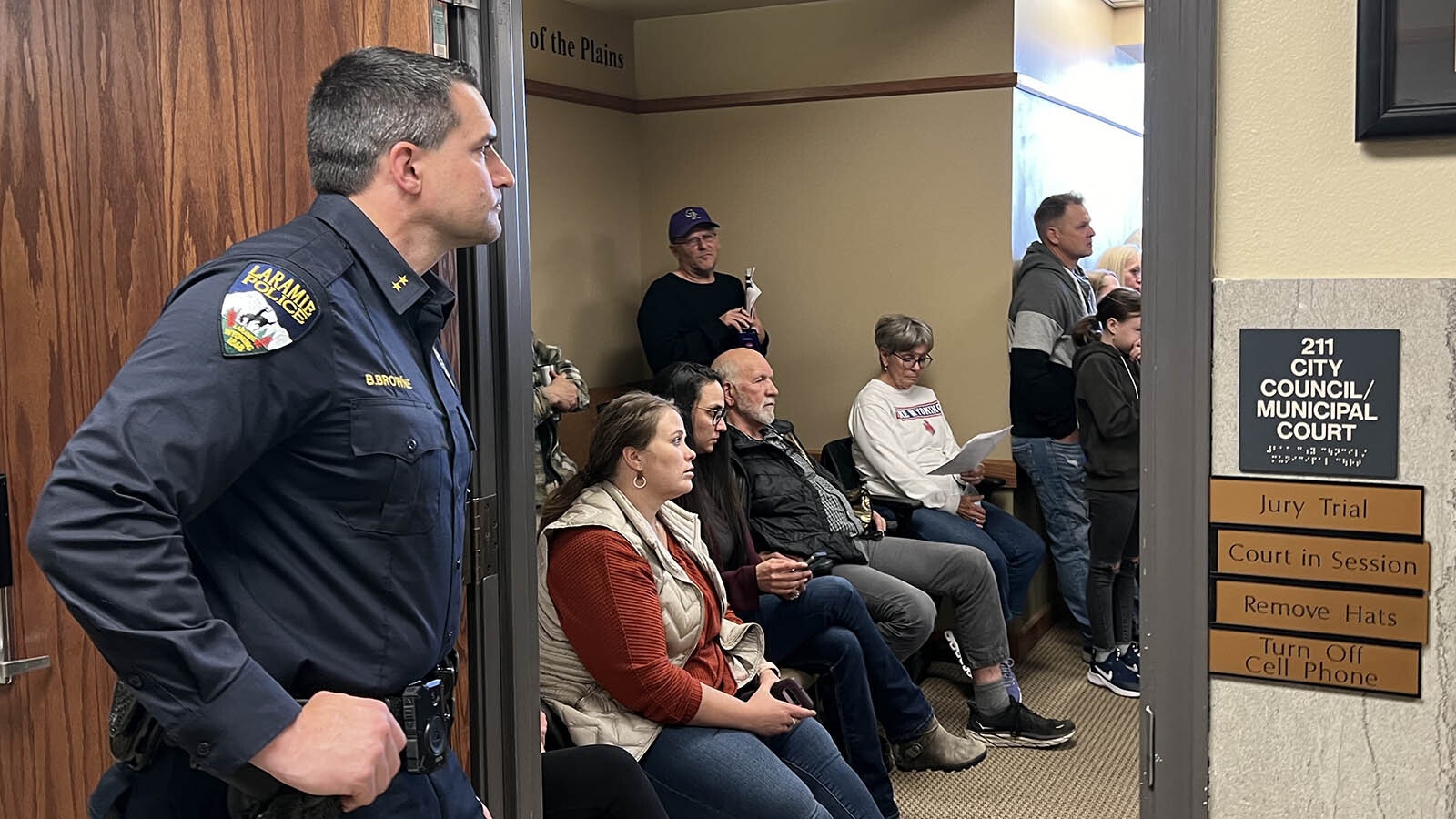 Laramie Police Chief Brian Browne stands outside a packed city council chamber late Tuesday. Residents and business owners showed up to speak against a proposed downtown apartment building.
