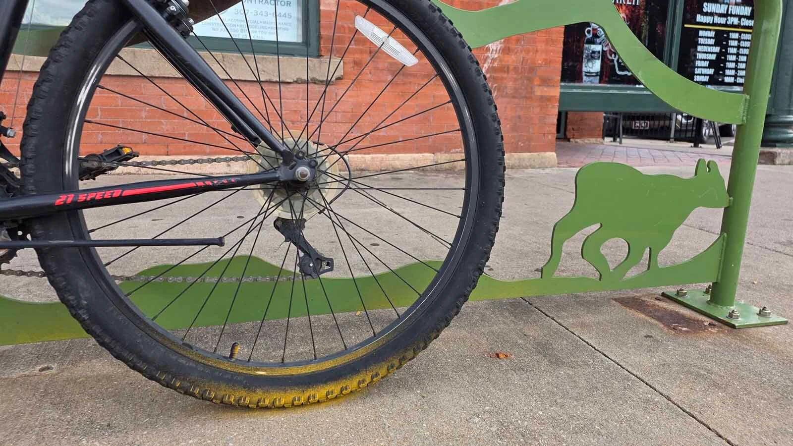 The yellow paint overspray on a botched curb painting job in downtown Laramie also hit nearby bicycles and bike racks.