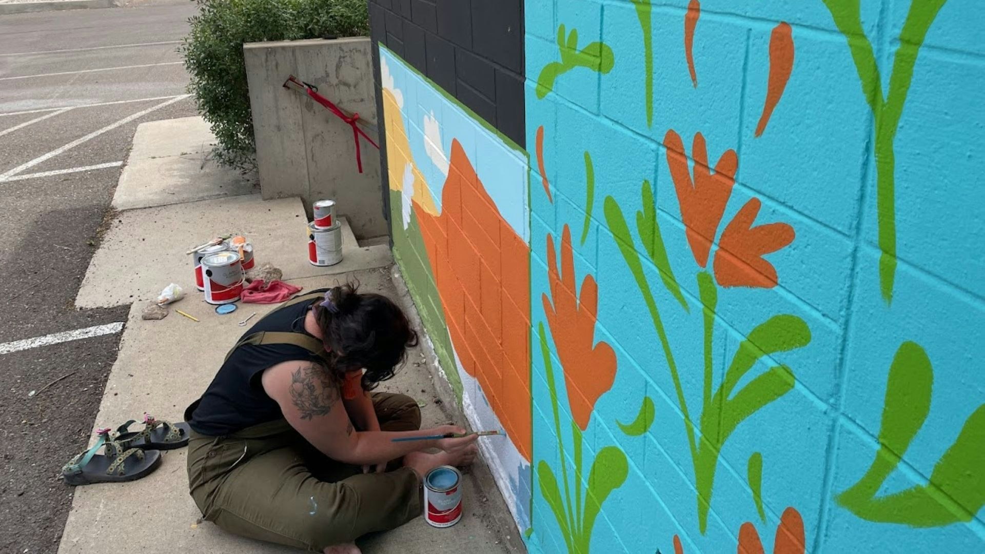 Artist Jodie Herrera works on a mural in downtown Laramie.