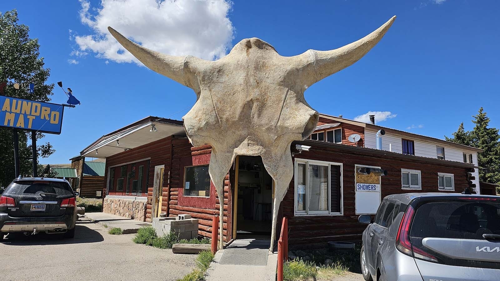 A giant 15-foot buffalo skull made by Vic Lemmon from fiberglass forms the entry of the Laundromat and Carwash in Dubois, Wyoming. It will also be a temporary art gallery when it hosts a unique exhibit.