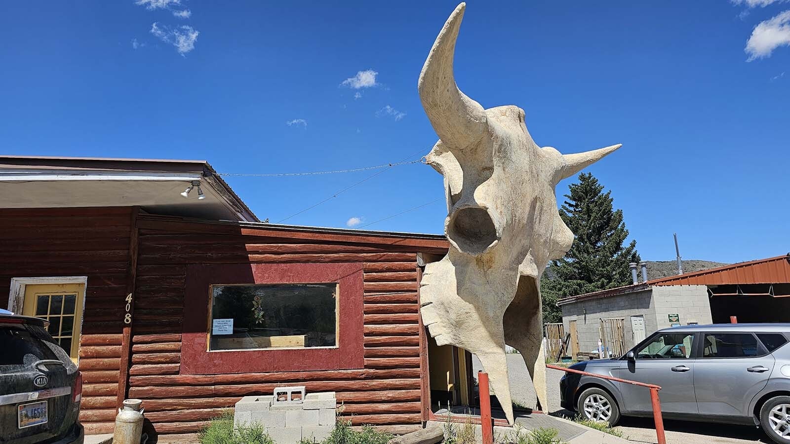 A giant 15-foot buffalo skull made by Vic Lemmon from fiberglass forms the entry of the Laundromat and Carwash in Dubois, Wyoming. It will also be a temporary art gallery when it hosts a unique exhibit.