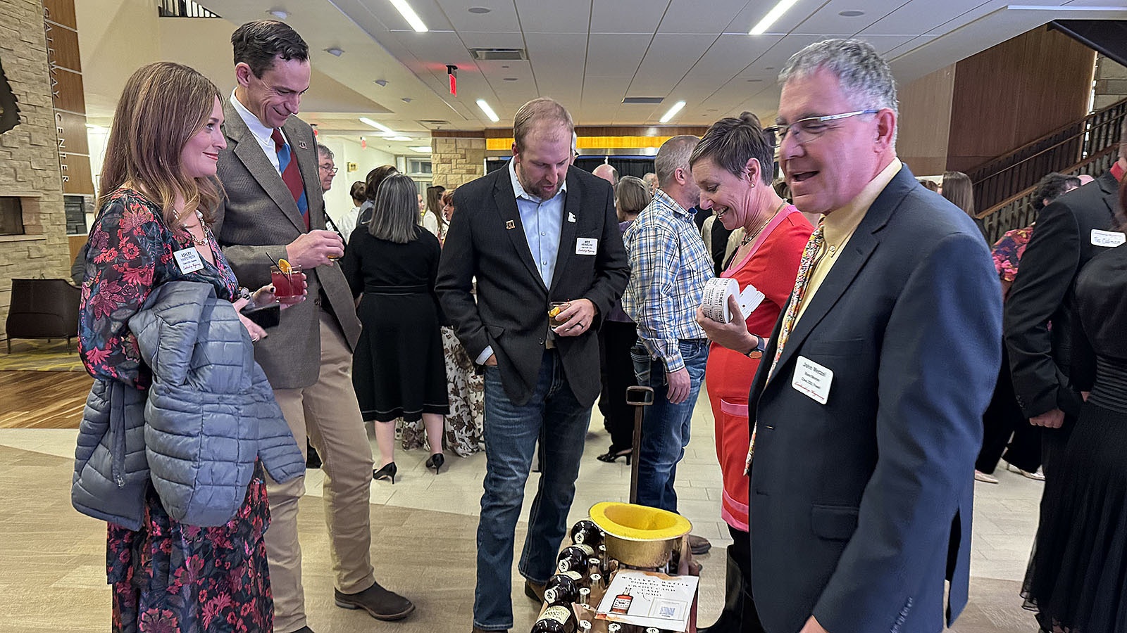 Leadership Wyoming graduates consider buying a ticket for a wagon of Wyoming Whiskey during Leadership Wyoming's 25th Anniversary celebration in Laramie.