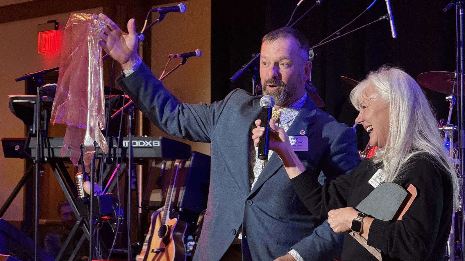 Eric and Kelly Barlow accept the Host of the Year Award during Leadership Wyoming's 25th Anniversary celebration in Laramie. Eric Barlow offered a shoulder-length plastic glove to every Leadership Wyoming graduate who "earned one" during a visit to his ranch outside Gillette.