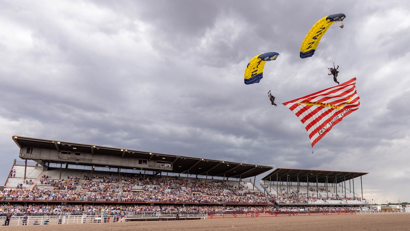 The Navy Leap Frog parachute team always gets a huge crowd pop when it drops in from thousands of feet in the air with a huge American flag.