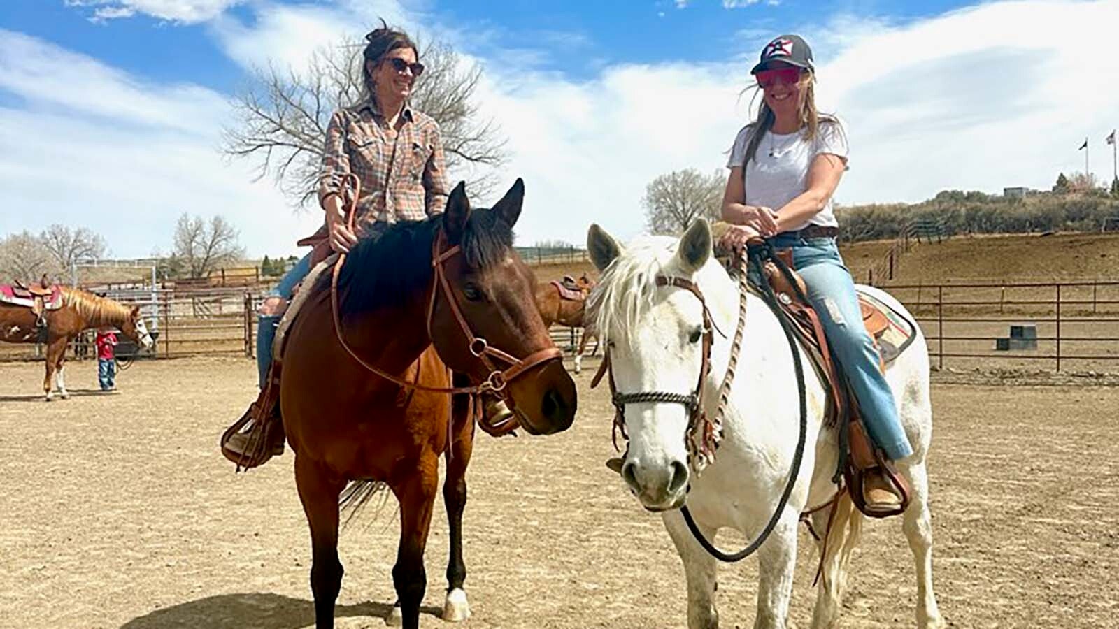 Angie Valcarce and Megan Robinson on their horses at a Wyoming Horsemanship Academy lesson in Cody.