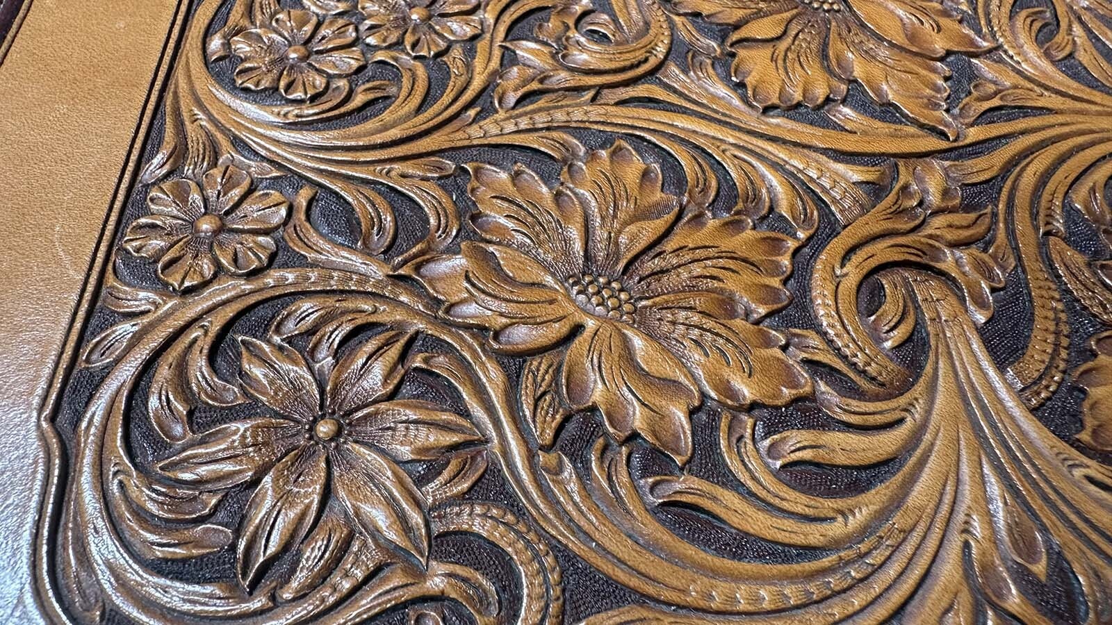The Sheridan Style is a unique flower and vine design created by Don King and used by many leather artisans including  Master Leather Craftsman James “Jim” Jackson of Sheridan, Wyoming. It features a flowing design that draws its viewer around the page instead of concentrating on the flowers.