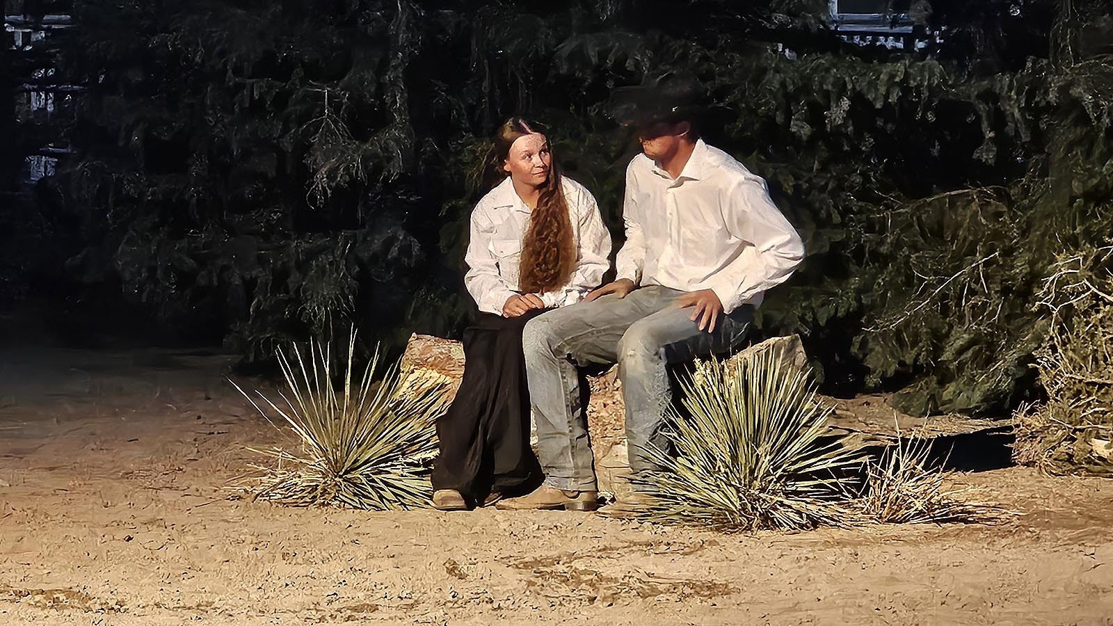 A pair of young lovers discuss a private matter during Legend of Rawhide.