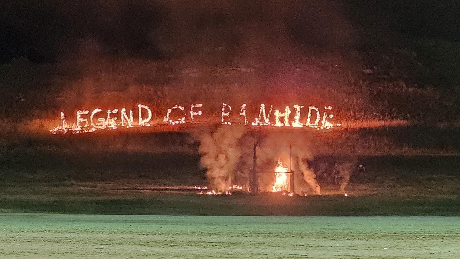 The hillside is set on fire to spell out Legend of Rawhide.