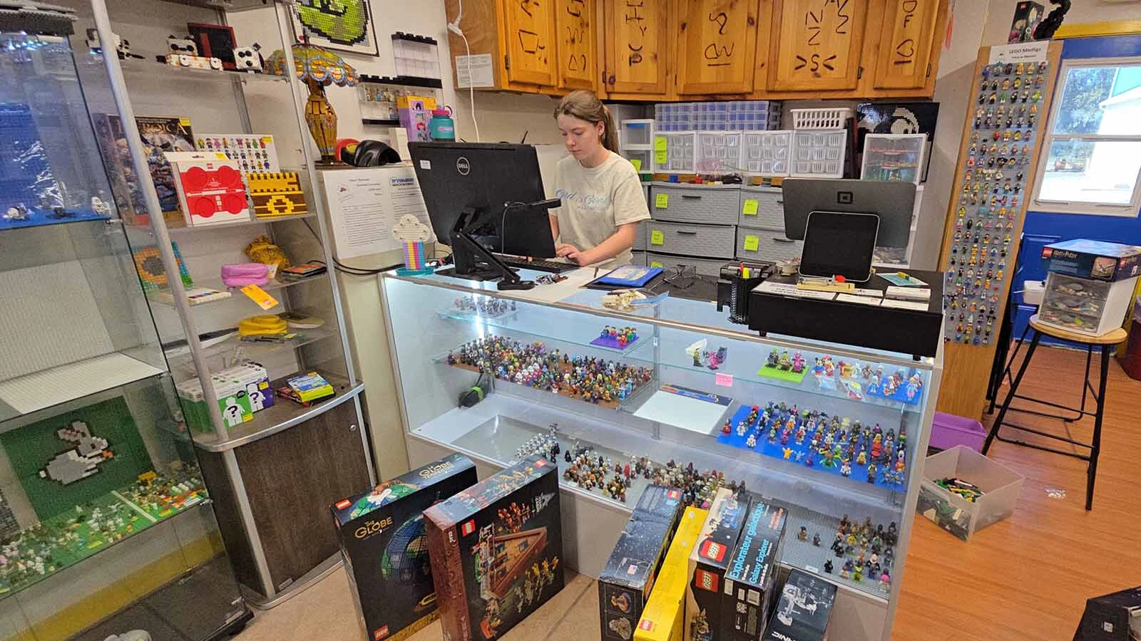 Amelia Dix works on the computer at her family's LEGO store, Wyoming BrickWorks in LaGrange.