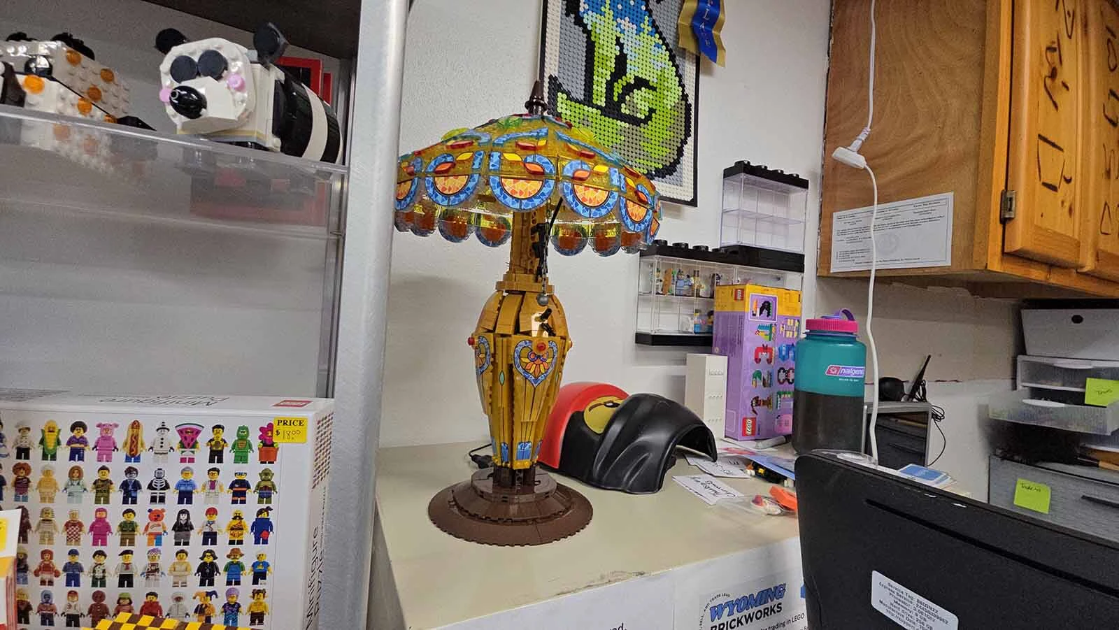 The lamp is not by LEGO, but is an example of the kinds of items that show up at the store unexpected. The family decided to keep this particular one for the store.