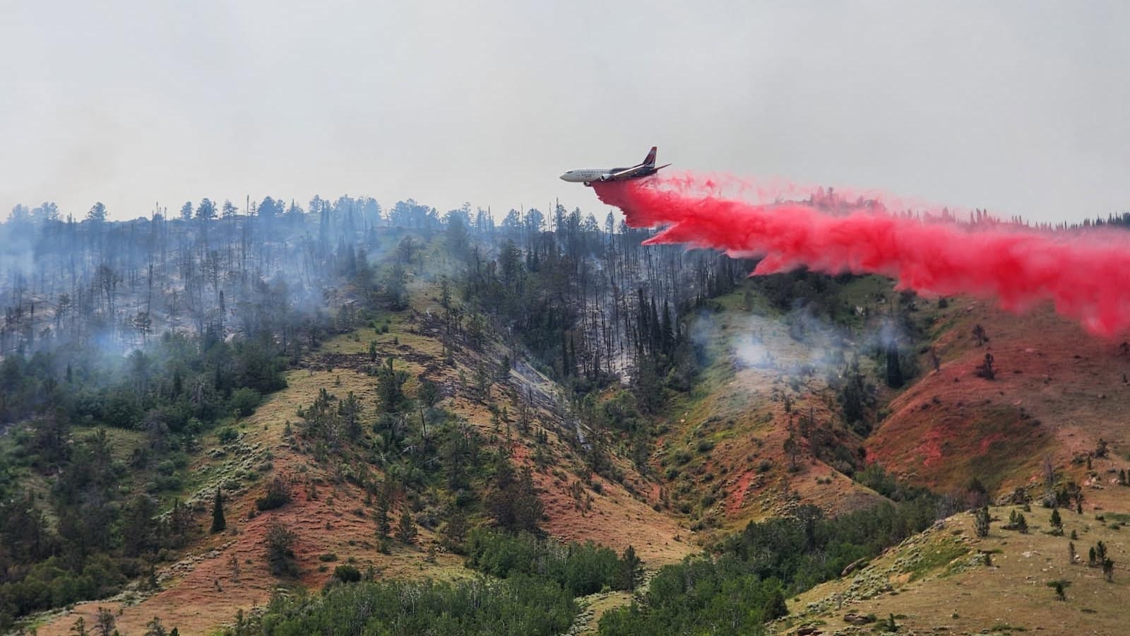 A slurry bomber airplane, under contract with the Wyoming State Forestry Division, helps fight the Muddy Fire near Casper.