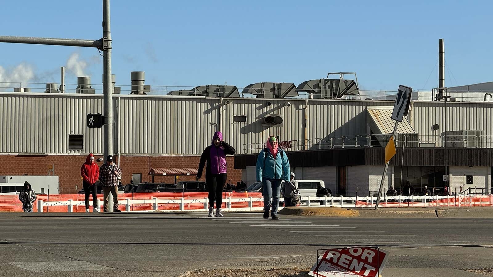 Tyson workers cross Plum Creek Parkway after their shift ends.